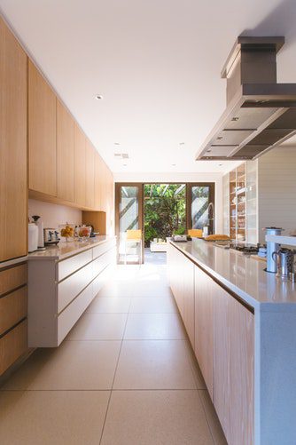 tiled floor and white kitchen cabinets