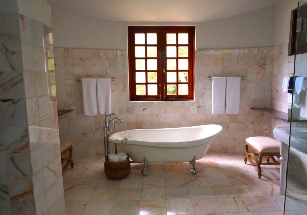 freestanding bathtub model on pink tile