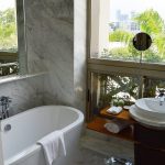 Freestanding oval soaking tub with marble surround