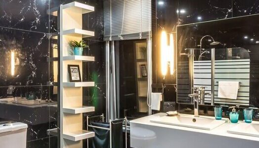a white bathroom vanity against black marble walls
